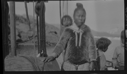 Image of Inuit child in hood. 2 other children